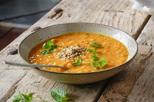 Pumpkin, kaffir lime & lentil curry w’ tamari seeds & ginger carrot pickle